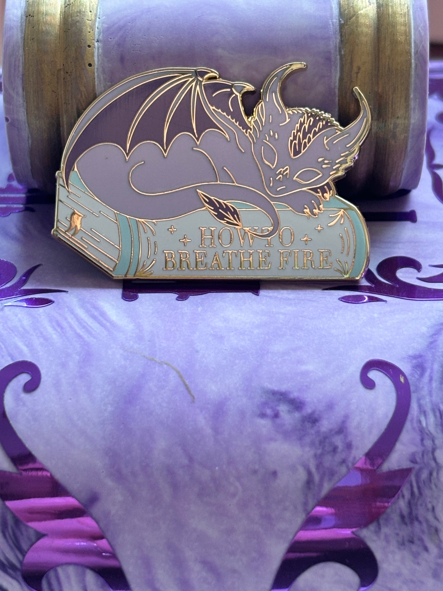 Baby Sleeping Dravon Bookstack Pin Badge. How to breathe fire.
